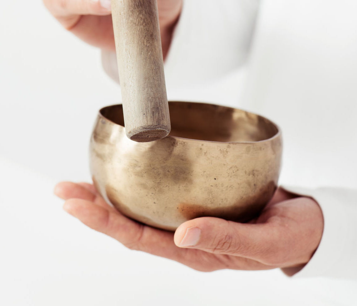 Woman playing a Tibetan singing bowl.