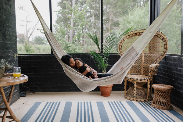 Image of mom and child in a hammock.