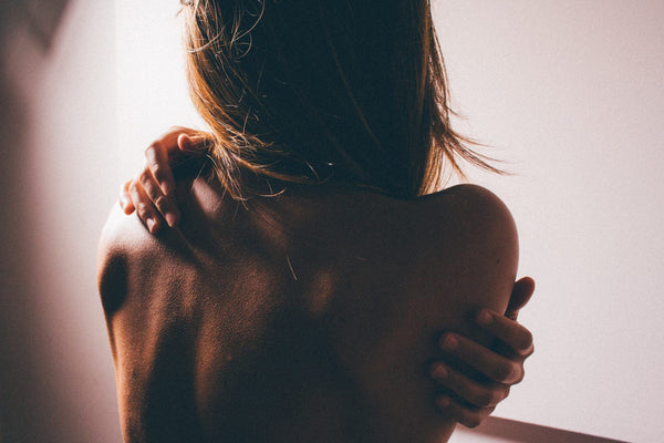 A young blonde woman's back.